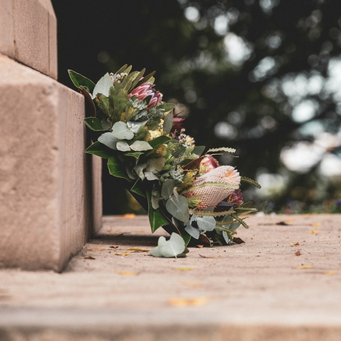 pink and green flower bouquet on brown concrete wall