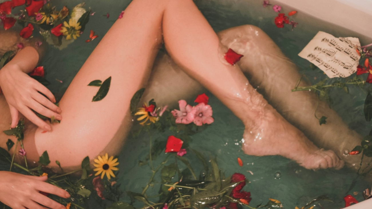 bathtub with water and flowers