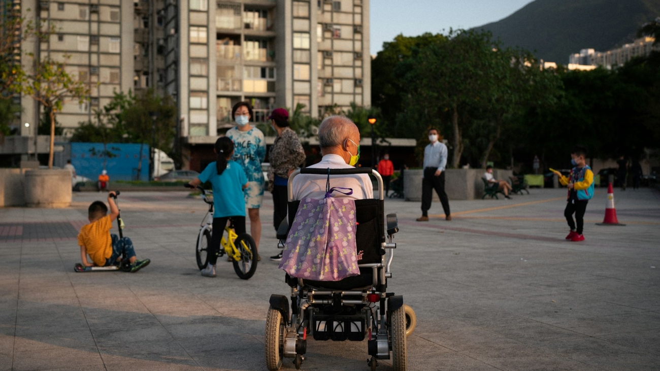 woman in pink shirt riding on black and red wheel chair