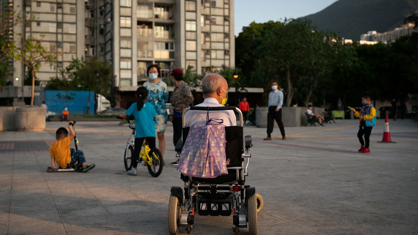 woman in pink shirt riding on black and red wheel chair