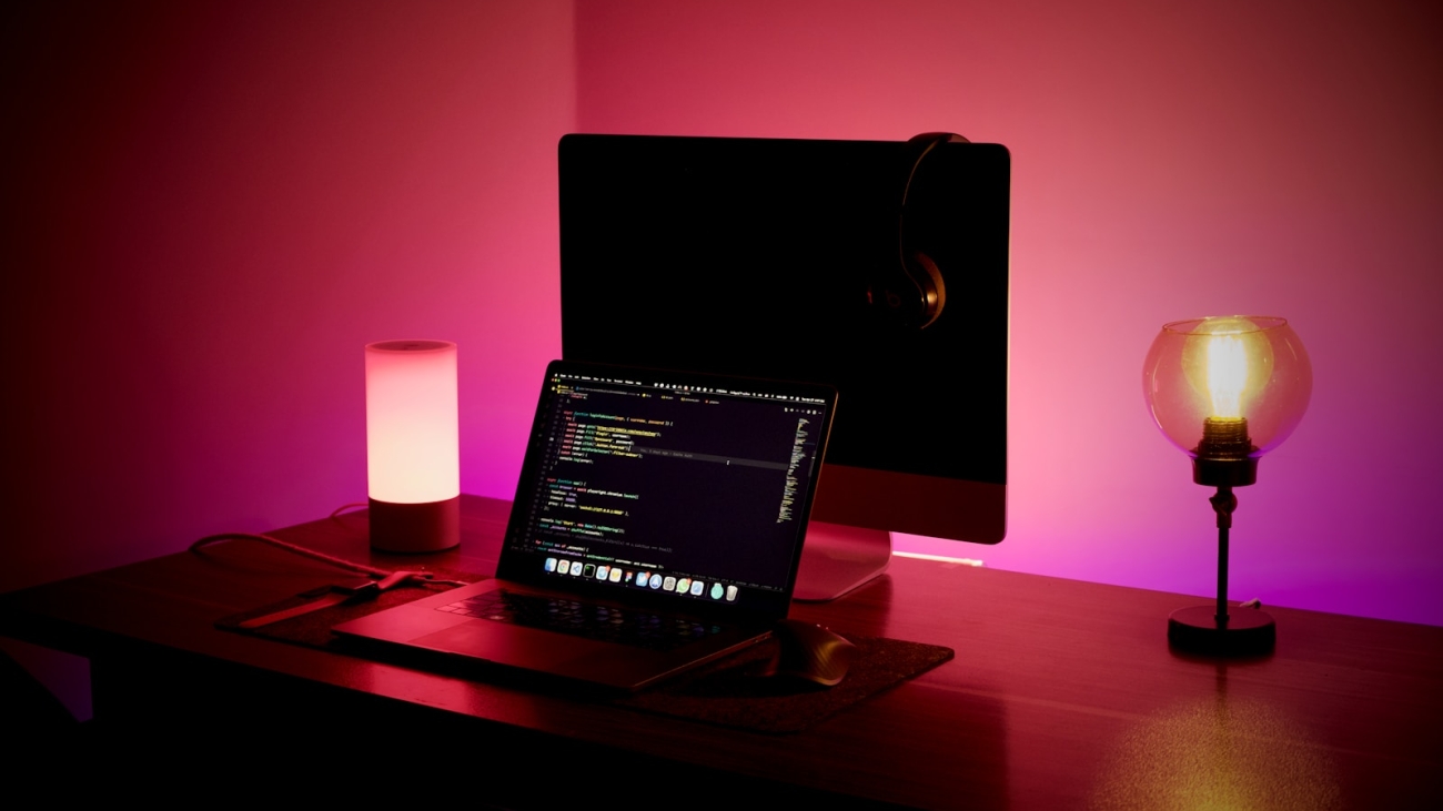 a laptop and a candle on a table