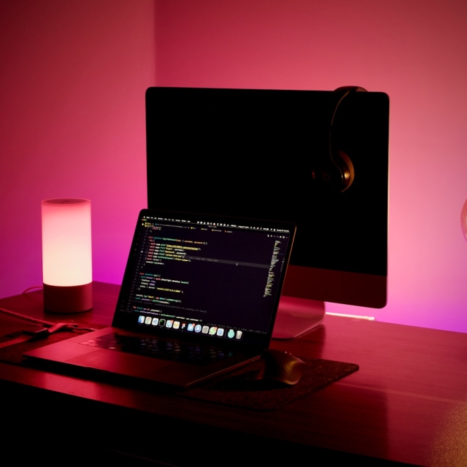 a laptop and a candle on a table