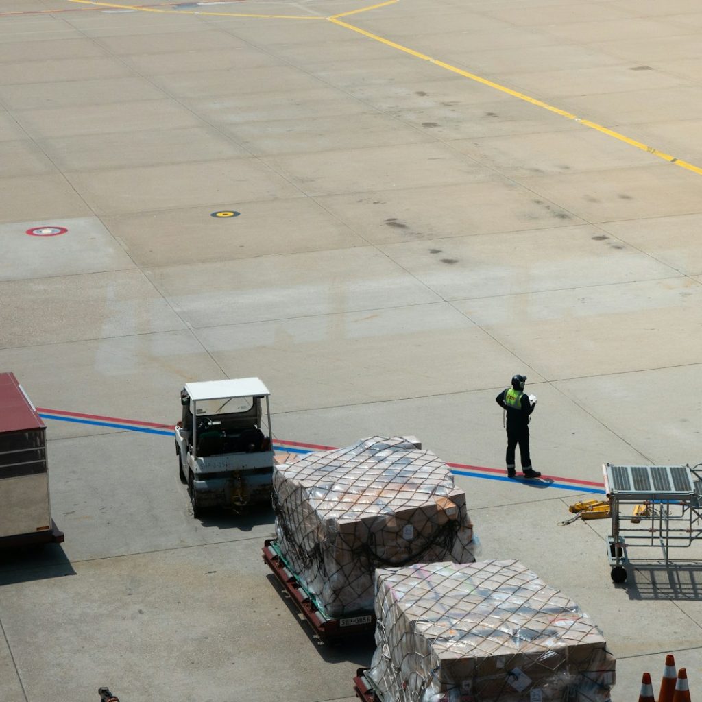 A man standing on the tarmac of an airport
