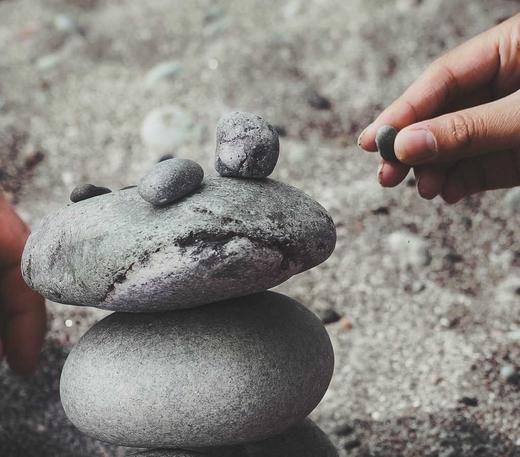 person balancing rocks