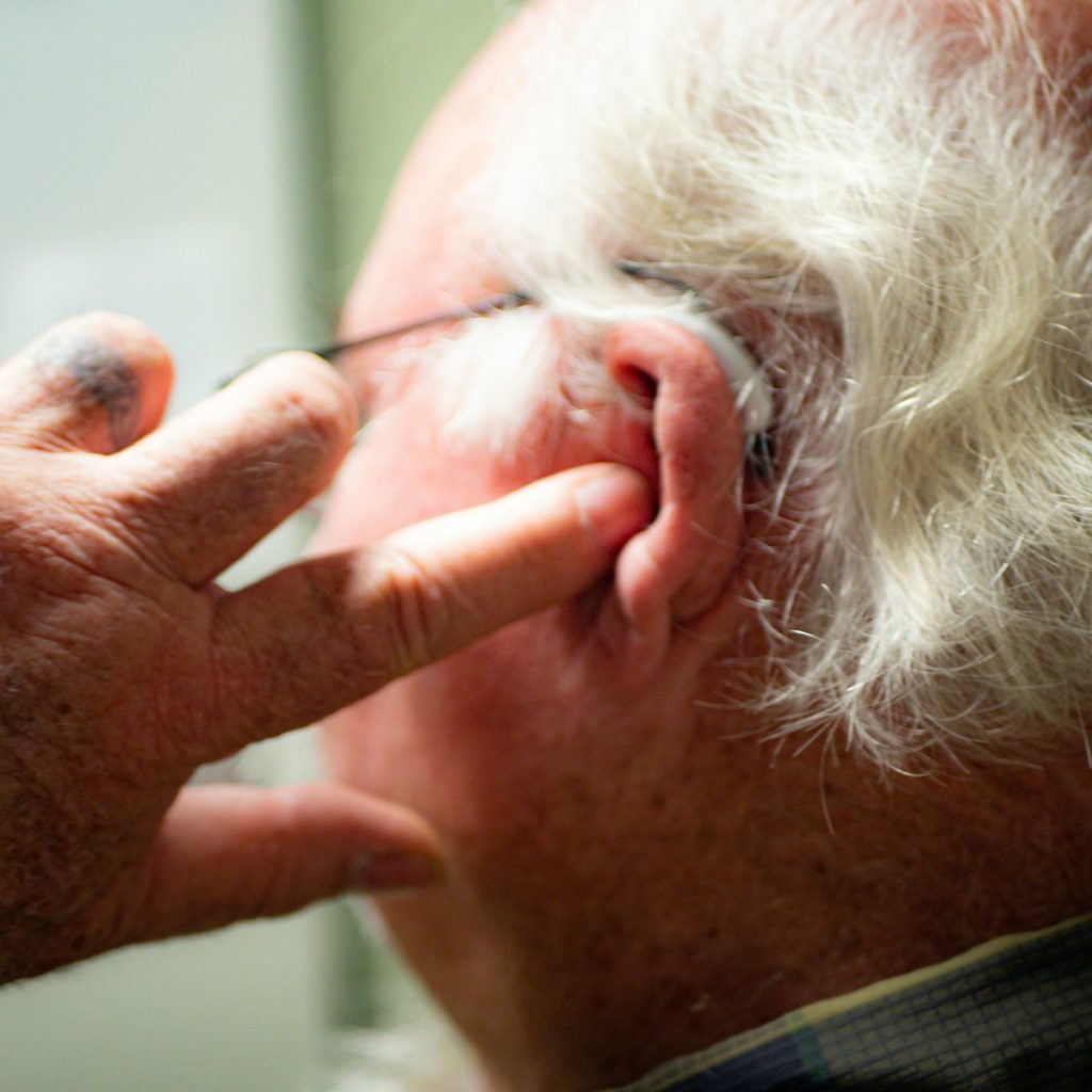 a man with his hand on his face
