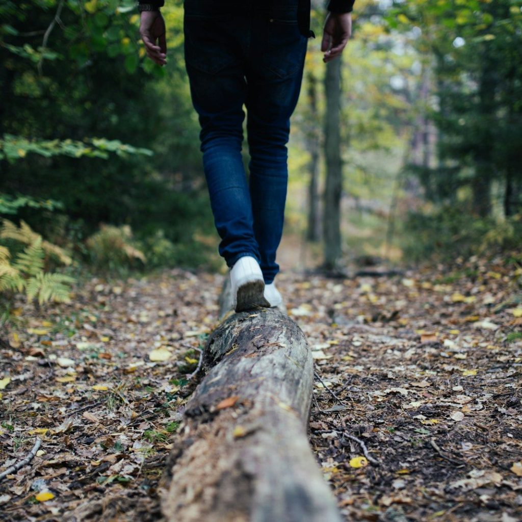man walking on forest