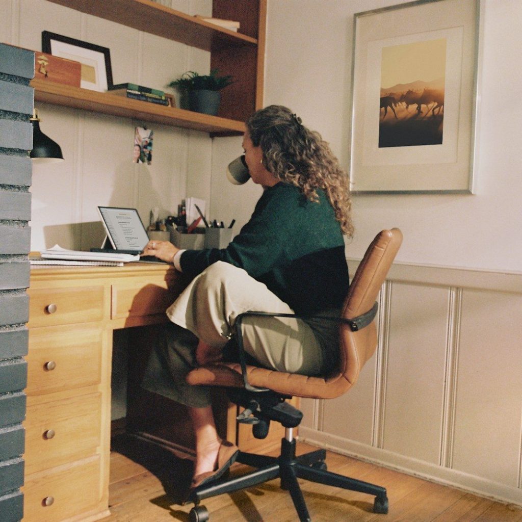 Woman working at desk with coffee