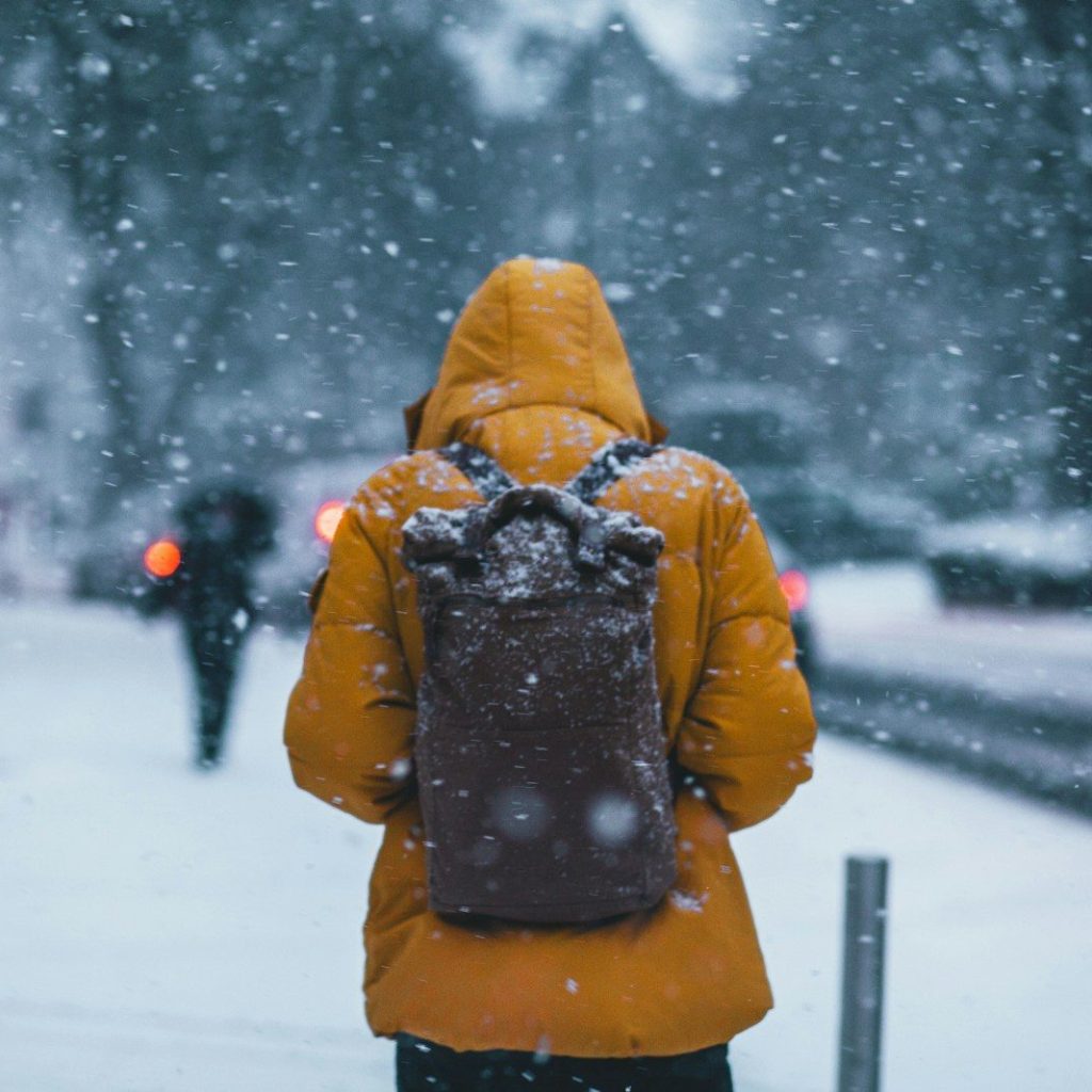 person wearing jacket and backpack